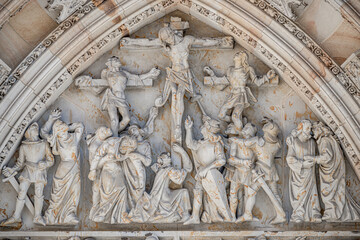 Crucifixion of Christ scene at major entrance portal of Saint Vitus Cathedral in Prague, Czech Republic, details, closeup