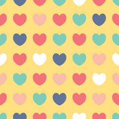 Colourful love hearts on a yellow background. Simple fun seamless pattern for giftware, textiles and fashion.