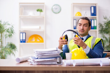 Young male architect working in the office