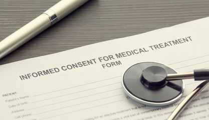 informed consent for medical treatment form on the desk.
