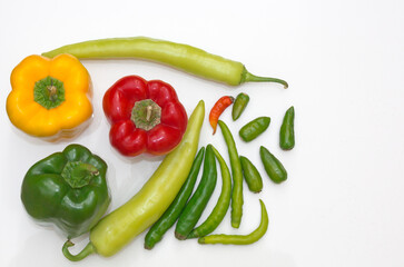 Different species of Farm Fresh  Indian hot chilies and Bell peppers in Colors of Red,Green and Yellow in a single frame in Food Photography.