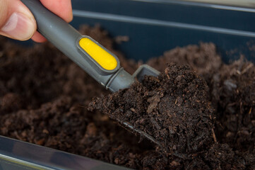 Garden soil on mini spade from hobby gardener on balcony
