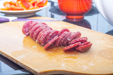 Sliced smoked sausage on a wooden board
