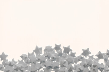Light background of white matte paper stars located on bottom and an empty place for text.