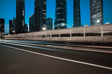 Empty road surface with city landmark buildings of night