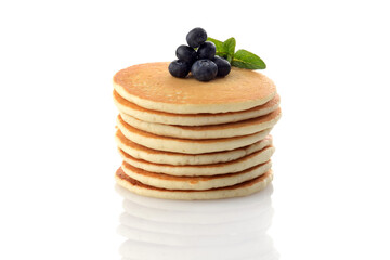 stack of pancakes with blueberries on white