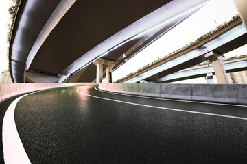Empty road floor with city viaduct bridge of neon lights night
