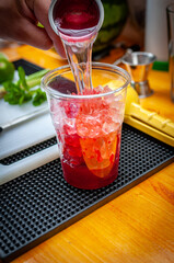 Preparation of cocktail. Adding ice, shaking ingredients and decorating with mint