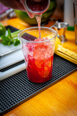 Preparation of cocktail. Adding ice, shaking ingredients and decorating with mint