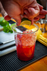 Preparation of cocktail. Adding ice, shaking ingredients and decorating with mint