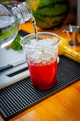 Preparation of cocktail. Adding ice, shaking ingredients and decorating with mint