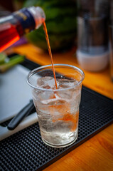 closeup of preparation aperol cocktail with slice of orange