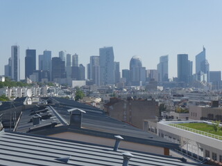 La Défense business district in a blue sky with zinc roofs at the front