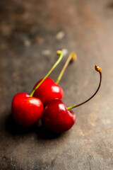 Ripe and juicy cherries on the dark rustic background. Selective focus. Shallow depth of field.