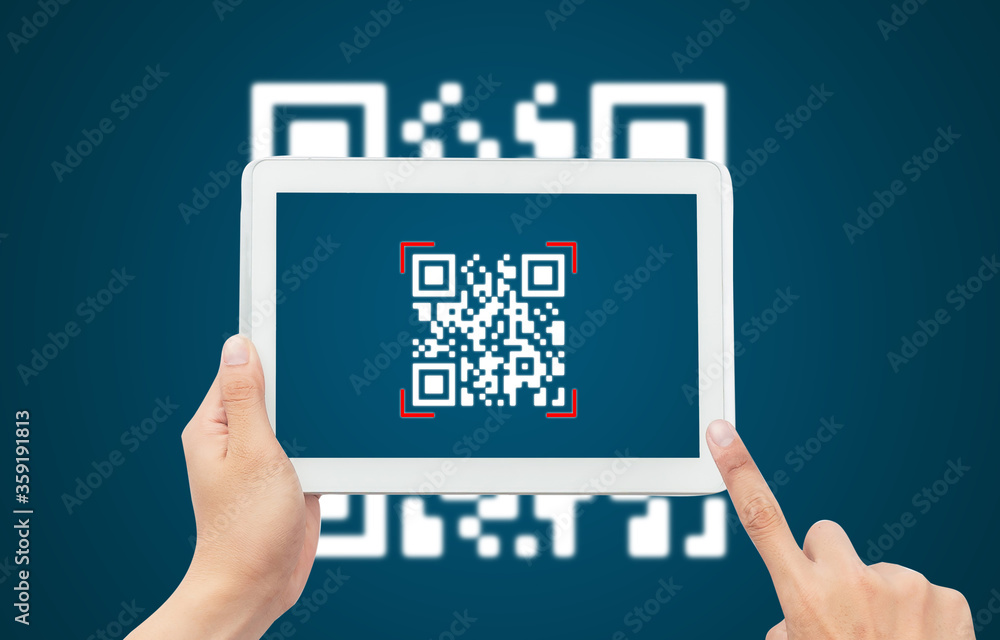 Wall mural hand using tablet computer scan qr code on blue background. cashless technology and digital money co