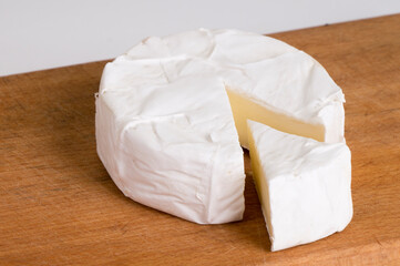 pieces of soft cheese Camembert on dark blackbackground. Delicious pieces of white mold cheeses with soft textures Camembert close up, macro
