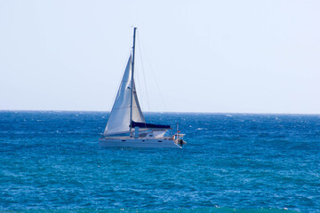 Sailing. Ship yachts in the open blue azure Mediterranean Sea. Blue sky. Free copy space. Concept of relax and water sport