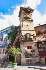 Fototapeta na wymiar Crooked clock tower of Rezo Gabriadze Tbilisi Teatr Marionette in Tbilisi, Georgia