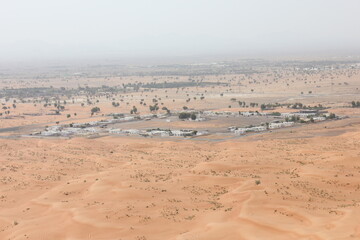 Hot and arid desert sand dunes terrain in Sharjah emirate in the United Arab Emirates. The oil-rich UAE receives less than 4 inches of rainfall a year and relies on water from desalination plants.
