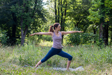 A woman doing yoga in the park