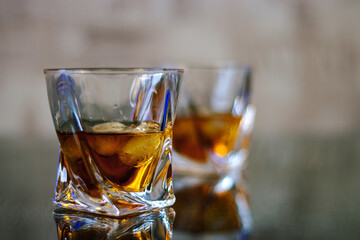Glasses of whiskey are on the table. Close up