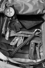 Fototapeta na wymiar Compass, knife and multitool in a tourist backpack