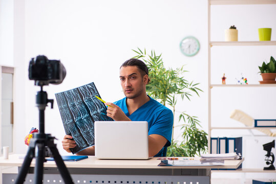 Young male doctor recording video for his blog