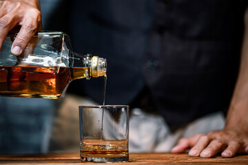 Bartender Serve Whiskey on wood bar