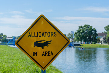 Alligators in Area sign on Bayou St. John in New Orleans, Louisiana, USA