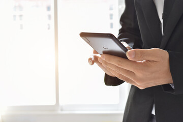 Close up of businessman using a cell phone. Young business executive with mobile phone .