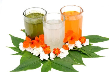 glass of orange, green mint, lychee juice and flowers or leaves