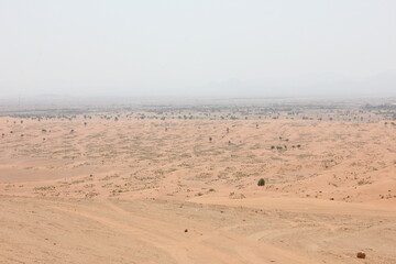 Hot and arid desert sand dunes terrain in Sharjah emirate in the United Arab Emirates. The oil-rich UAE receives less than 4 inches of rainfall a year and relies on water from desalination plants.