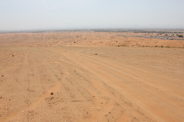 Hot and arid desert sand dunes terrain in Sharjah emirate in the United Arab Emirates. The oil-rich UAE receives less than 4 inches of rainfall a year and relies on water from desalination plants.