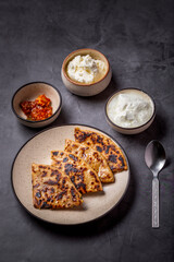 Aaloo parantha or stuffed potato flatbread with curd, pickle and homemade white butter