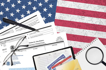 USCIS form I-130 petition for alien relative lies on flat lay office table and ready to fill. U.S....