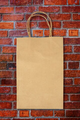 blank paper bag on brick wall