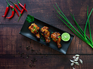 BBQ Chicken Legs with lime
Topped with Spring onion,Chili,Garlic, Pepper,Barbecue sauce as an ingredient
Wood background
