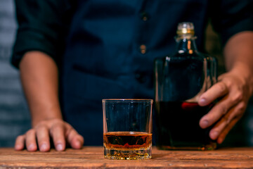 person holding a glass of whiskey