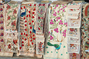 Market stalls with suzani an uzbek traditional embroidery decorative tribal textile with colourful pattern made in Central Asian, Uzbekistan