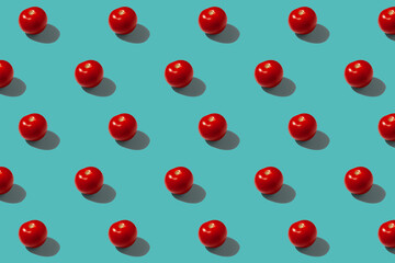 Red tomatoes on a turquoise background pattern