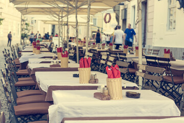 Empty tables waiting for hungry guests at outdoor restaurant.