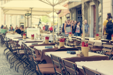 Empty tables waiting for hungry guests at outdoor restaurant.