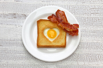 Egg in a hole of bread then toast that also known as egg in the basket.
