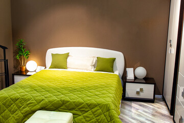 Interior of modern cozy bedroom. Double bed and table lamps