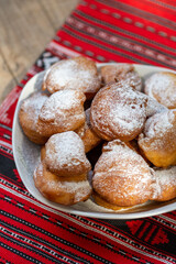 romanian mini doughnuts on a plate on red traditional cloth