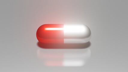 The image was created with a three-dimensional program the medicine capsules with red and white color place on a silver background