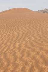 Hot and arid desert sand dunes terrain in Sharjah emirate in the United Arab Emirates. The oil-rich UAE receives less than 4 inches of rainfall a year and relies on water from desalination plants.