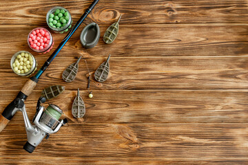 Accessories for carp fishing and fishing baits on wooden planks with copy space