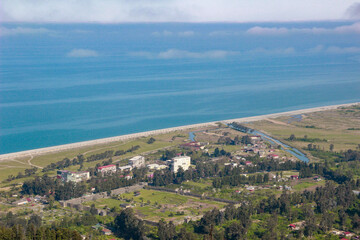 Fototapeta na wymiar View of Gonio Apsaros Fortress, Black Sea beach and surrounding apartment buildings. Georgia, Gonio