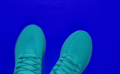 Stylish men's sports shoes for running on a blue background. Top view